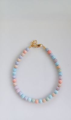 "Pastel Rainbow Bracelet. This bracelet is made with the semi precious Mongolia Alxa Rainbow Agate gemstone beads. These beads have been known to be healing. This unique and bold bracelet will catch the eye and is a unique accessory to complete any outfit! Wear it alone, or stack with multiple bracelets. It is handmade with high-quality materials that will last. All of our bracelets can be made for infant, toddlers, girls, teens, and women! PLEASE READ SIZING DETAILS BEFORE ORDERING: For the best fit, measure snug around the wrist with a measuring tape of a piece of string against a ruler. Then add 1/2 an inch and order the corresponding size from my recommended sizing chart. This ensures the most comfortable fit. Each bracelet comes with a 1/2 inch extender chain, so there is also room to Pastel Colorful Beads Bracelets As Gift, Pastel Bracelets With Colorful Beads For Gift, Pastel Colorful Beads Bracelet As Gift, Adjustable Pastel Bracelets With Round Beads, Pastel Beaded Bracelets As Gift, Pastel Beaded Bracelets For Gift, Pastel Beaded Bracelets Gift, Adjustable Pastel Beaded Bracelet, Pastel Round Beads Jewelry Gift