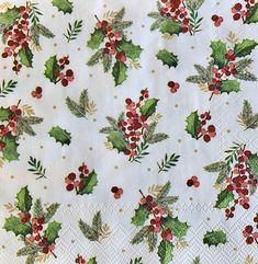 holly and berries on white paper napkins with gold dots