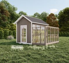 a small shed sitting on top of a lush green field