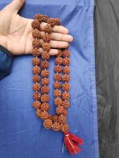 Rudraksha Origin:- Nepali Rudraksha (Premium Quality) 5 Face/Mukhi Rudraksha Pathri Mala (Premium quality) Beads - 54 + 1 Wearing Each beads Size - 19 - 20 MM (Apx.) Traditional Beaded Necklaces For Rituals And Festivals, Handmade Beaded Necklaces For Puja Festivals, Traditional Tilla Beaded Necklaces For Puja, Traditional Beaded Necklaces For Diwali Rituals, Temple Jewelry Beaded Necklaces For Puja Festivals, Temple Jewelry Mala With 108 Beads For Puja, Temple Jewelry Mala With 108 Beads For Rituals, Beaded Tilla Necklaces For Puja And Diwali, Temple Jewelry Mala With Round Beads For Meditation