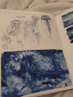 an open book with pictures of jellyfish and other marine creatures on it's pages