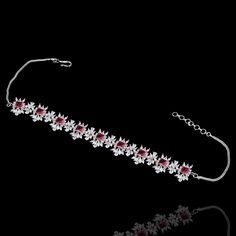 For edgy style and sophisticated sparkle, this necklace set is a dream come true! Elegant and shimmering set with CZ and ruby stones creating a flawlessly fresh finish for each and every one of your evening ensembles. The set includes a choker paired with a necklace, a matching teekah and a pair of beautiful earrings. Approximate earrings length is 2.1". Please click on the video for a detailed view of the product. Designed over a high-quality brass as base metal. Available in 3 plating options. Elegant Red Choker For Formal Occasions, Ruby Necklaces With Sparkling Stones For Party, Party Ruby Necklaces With Sparkling Stones, Party Ruby Necklace With Sparkling Stones, Elegant Ruby Choker As A Gift, Elegant Red Choker Jewelry Sets, Dazzling Ruby Bridal Necklace For Parties, Elegant Ruby Bridal Necklace For Party, Unique Gift Cards