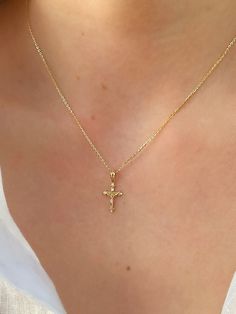 This unique dainty Crucifix Cross Necklace features a small gold cross with a high polish finish that sits on a delicate 14K Yellow Gold chain. It's perfect for layering with your favorites or styled solo for a classic look. Necklace Length: 16 Inches *with a 2-inch extension Pendant Length: 1.6 cm * Bail: 0.4 cm Pendant Width: 1 cm Chain Type: Flat Cable Clasp: Lobster Metal: 14K Yellow Gold (stamped) Good Cross Necklace, Small Gold Cross Necklace, Gold Jewelry Cross, Gold Cross Necklace Aesthetic, Simple Cross Necklace Gold, Crucifix Necklace Women, Cross Necklace Aesthetic, Cross Gold Necklace, Gold Cross Necklace For Women