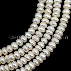 three strands of white pearls on a black background