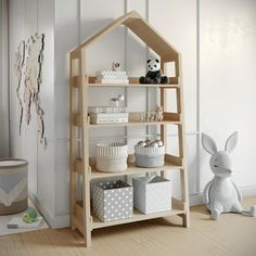 a wooden shelf filled with cupcakes next to a stuffed animal on the floor