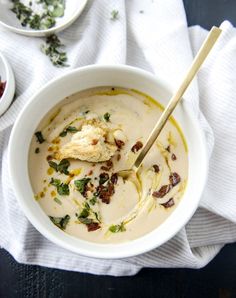 a white bowl filled with soup on top of a table