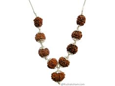 Navgrah Rudraksha Beads Kantha Mala- (Siddha mala) is a Powerful and unique Rudraksha Navagraha Kantha. This Navgrah Rudraksha Beads Kantha consists of Rudrakshas from 2 Mukhi to 9 mukhi (1 each) + 12 Mukhi. There is a silver chain attached to the pendant. This Siddh Mala Silver Pendant appease all the negative planets and gives power to benefic planets. Navgarh Rudraksha kantha is the one pendant, which should definitely be worn by everyone. It does not have any negative effect. It would defini Fusion Style Necklaces For Puja, Temple Jewelry Necklaces With 8mm Beads For Festivals, Spiritual Polished Beads Necklace For Puja, Polished Beads Spiritual Necklaces For Puja, Spiritual Necklaces For Puja With Polished Beads, Silver Spiritual Beads For Festivals, Silver Mala For Puja And Diwali, Silver Mala For Puja During Diwali, Silver Mala For Puja On Diwali