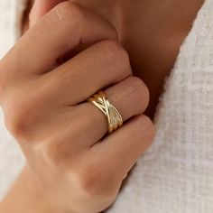 a woman's hand with a gold ring on it