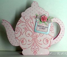 a pink teapot shaped card with a rose on it