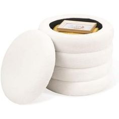 white round cotton pads with gold foil in the center and black lining on each side