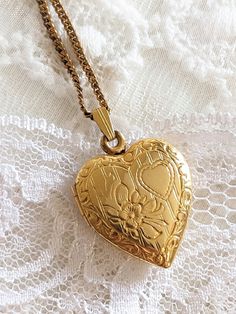 ABOUT: The loveliest 1940s vintage floral etched heart locket. HEART LOCKET MATERIAL: Gold filled  STAMPED /20 12KT. G.F CONDITION: In beautiful & excellent vintage condition. Minimal wear & patina on locket. The locket is an absolute beauty & makes the sweetest keepsake & can be easily added to any standard chain. I will include the chain it was found with, not sure the material of chain it is not signed. The chain has some patina. The chain measures 17 inches long. Please see video and all photos for quality. ADDITIONAL INFORMATION: Please note all jewelry pieces are vintage/antique & one of a kind pre-owned & pre-loved. All items are found & sold as is & may be used or may have some signs of wear, patina and or superficial scratches. Listing is for one sweetheart locket and other  neckl Vintage Antique Gold Heart Pendant Necklace, Antique Gold Heart Pendant Vintage Necklace, Vintage Antique Gold Keepsake Necklace, Vintage Necklace For Valentine's Day, Vintage Necklaces With Vintage Charm For Valentine's Day, Vintage Locket Necklace With Heart Charm For Gifting, Vintage Heart Charm Locket Necklace As A Gift, Vintage Necklaces For Valentine's Day Anniversary, Valentine's Day Antique Gold Locket Necklace With Vintage Charm