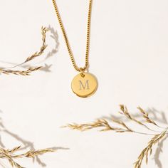 Looking for a special piece of jewelry that's both elegant and personalized? Look no further than this beautiful initial coin necklace that's customized with your chosen initial! PREMIUM MATERIAL -- Made from premium stainless steel and 14K Gold, and designed to last. This necklace is both tarnish-resistant and hypoallergenic, so it's perfect for sensitive skin. PERSONALIZED TAG -- Perfect for anyone who loves to express their individuality through their accessories.  Note: If a font is not given, you will receive the font that is pictured for your order which is font #1. FANCY DESIGN --  Designed for creating a truly fancy and one-of-a-kind piece. Engraved into coin pendants and creates a classy high-class look impression, which is perfect to wear every day on any occasion. PERFECT FOR HE Classic Yellow Gold Initial Necklace For Mother's Day, Mother's Day Yellow Gold Classic Initial Necklace, Mother's Day Classic Yellow Gold Initial Necklace, Personalized 14k Gold Initial Necklace For Anniversary, Classic Monogram Initial Necklace For Anniversary, Classic Yellow Gold Initial Necklace For Personalized Gift, Classic Initial Necklace For Anniversary And Mother's Day, Classic Yellow Gold Initial Necklace For Anniversary, 14k Gold Monogram Initial Necklace For Anniversary