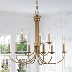 a chandelier hanging from the ceiling in a room with white walls and windows