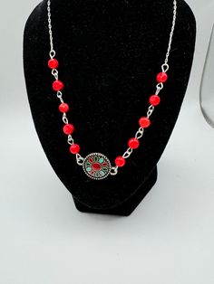 Dyed red coral beads on either side of a        Southwestern style focal charm. Necklace is 19.5" in length with a lobster claw clasp. The chain, focal charm, clasp and pins are all nickel free. Adjustable Red Beaded Necklace In Southwestern Style, Nickel Free Southwestern Style Necklace With Round Beads, Southwestern Style Red Necklace For Festivals, Southwestern Style Red Jewelry For Gift, Southwestern Style Red Festival Jewelry, Nickel Free Southwestern Style Round Necklace, Red Beaded Dangle Necklaces, Southwestern Style Red Jewelry For Gifts, Red Beaded Sterling Silver Jewelry