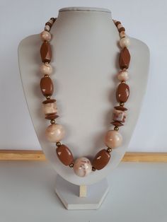 very beautiful piece! Vintage Retro chunky milk chocolate brown and swirl milk chocolate brown and biege lucite plastic beaded necklace with gold metal accent and different shapes and sizes of beads with lustrous surface with no seems and claps.  Circa 1975-1980. length: 24.5 inches; biggest ball beads: 7/8 inches diameter. good condition  To make this a smooth and pleasant transaction experience for everyone, all buyers need to read and understand the description, the terms of sale , the payment and the shipping indicated in this listing. Return not accepted - please ask before purchase. Thank you for watching our other items! A large collection of unique and unusual vintage items is listed. Plastic Necklace, Chunky Bead Necklaces, Chunky Beads, Vintage Lucite, Bead Jewellery, Necklace Vintage, Plastic Beads, Milk Chocolate, Metallic Accents