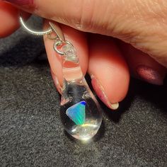 "My friend Marcy named this style of pendants. She said they look like Mermaid's tears. The hand blown teardrop dangle pendant is made by melting borosilicate glass tubing (pyrex) and blowing a bubble at the end of the tube in the flame. The pale blue Gilson opal polished nugget is then placed in the tube and is slowly melted so that the Gilson opal can be completely encased by the borosilicate glass and shaped into a teardrop. These opals flash a blue, green, yellow and even a little red color Hypoallergenic Glass Teardrop Jewelry, Silver Drop Glass Jewelry, Iridescent Teardrop Necklace For Gifts, Silver Glass Drop Jewelry, Silver Glass Teardrop Pendant Jewelry, Silver Glass Teardrop Jewelry, Silver Teardrop Glass Necklaces, Clear Drop-shaped Glass Jewelry, Clear Glass Drop Jewelry