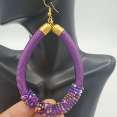 THE COLOR PURPLE! These large hoop earrings in purple with a mixture of beads are playful and so lightweight, making them a no brainer statement. Our favorite detail...subtle bead accents that add that little extra something. FEATURES ☆ Embroidery thread wrapped cord earrings☆ Beaded Accents☆ Color: Primary color purple with accent colors☆ Earring Back: Gold plated ball & coil fishhook ear wire☆ Earrings are light-weight ☆ Beautifully handmade by talented Kenyan artisans☆ Ships from the U.S. ☆ S Adjustable Hoop Earrings With Dangling Beads For Party, Adjustable Dangling Beads Hoop Earrings For Party, Adjustable Hoop Beaded Earrings For Party, Trendy Colorful Beaded Hoop Earrings For Parties, Colorful Beads Hoop Earrings For Party, Adjustable Purple Beaded Earrings With Colorful Beads, Purple Beaded Dangle Earrings, Purple Dangle Beaded Earrings, Trendy Purple Hoop Jewelry