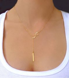 Vertical Bar Lariat Necklace  This sophisticated lariat necklace exudes luminous polish. Perfect for wearing alone or layering with other necklaces.  Vertical b Real Diamond Necklace, Gold Leaf Necklace, Gold Lariat Necklace, Bar Jewelry, Vertical Bar, Y Necklace, Gold Name Necklace, Dangle Necklaces, Gold Bar Necklace