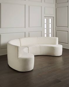 a white couch sitting on top of a hard wood floor