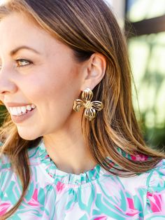 Blossom into spring with our timeless Alani Earrings. Featuring an organic shaped flower stud, these earrings introduce a delicate touch of floral sophistication to your everyday outfit. Organic shaped flower stud earrings 2.25" Brass plated Hypoallergenic Surgical steel posts Nickel and lead-free Feminine Drop Earrings For Spring, Chic Spring Jewelry With Flower Charm, Feminine Jewelry With Matching Earrings For Spring, Flower-shaped Jewelry With Matching Earrings For Spring, Elegant Spring Petal Shaped Flower Earrings, Spring Flower Earrings For Pierced Ears, Chic Petal-shaped Earrings For Gift, Gold Flower Earrings For Spring, Feminine Flower Charm Earrings For Spring