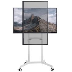 an image of a mountain with clouds in the sky is displayed on a tripod