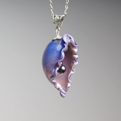 This Purple seashell necklace are made of glass in lampwork technique. It can be a bright addition to your outfit or a great gift for those who love the ocean! 👉 This item is made by hand, so the size, shape and color are different every time I make it. Please choose a necklace that you like from the available ones. Dimensions: total pendant height about 2 inch (50mm), see last photo for exact dimensions. Silver colored metal chain with adjustable length, 16-20 inches (40-50cm). Materials: arti Handmade Mermaid-shaped Ocean-inspired Necklaces, Unique Shell Necklace For Gift, Unique Shell-shaped Shell Necklaces, Ocean-inspired Shell-shaped Pearl Pendant, Ocean-inspired Shell Necklaces For Gifts, Ocean-inspired Shell Pendant, Ocean-inspired Shell Pendant Necklace With Lobster Clasp, Ocean-inspired Shell Pendant Necklace, Blue Shell-shaped Necklaces