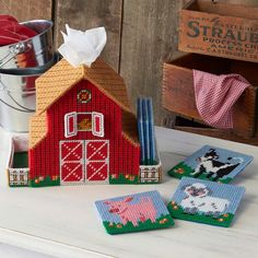 three coasters with farm animals on them and one has a barn in the background