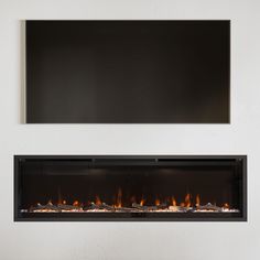 a white wall with a fire place in the middle and a black sign above it