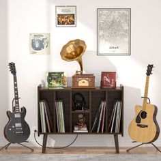 three guitars are sitting in front of a record player