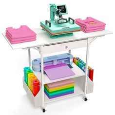 a toy sewing machine on top of a table with lots of crafting supplies in front of it