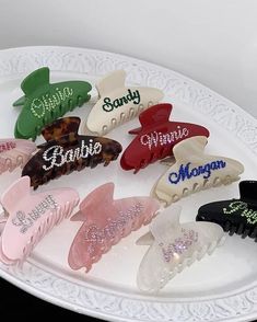 a white plate topped with lots of different colored hair clips