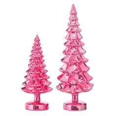 two pink glass christmas trees sitting next to each other