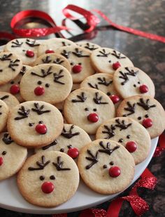 a plate full of cookies decorated like reindeers