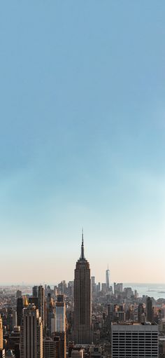 the city skyline is shown with skyscrapers in the foreground and an airplane flying overhead