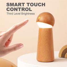 a wooden light that is on top of a white table with the words smart touch control third level brightness