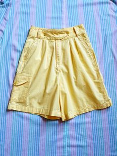 + super cute vintage eighties bright yellow camp shorts with flattering pleats & fun pocket details + ultra high waisted rise, roomy pant legs, & cinched waist, with belt loops for easy accessorizing & cool crossover double snap closure + the front features small pleats tucked into the waistband & two front pockets; the back has two pockets with envelope flap snap closure; the right leg has an extra envelope flap snap pocket on the side + the color is a bit brighter/more of a classic banana yell Summer Camp Care Package, Banana Yellow, Pocket Shorts, Red Shorts, Brand Tags, Cinched Waist, Pocket Detail, Vintage Baby, Shorts With Pockets