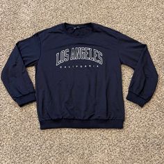 Shein Los Angeles California Lightweight Sweatshirt In Navy Blue Size Large. 22” Underarm To Underarm, 26” Long From Neckline To Bottom At Center Of Back. All Measurements Are Approximate And Taken Laid Flat. This Material Is Just A Little Heavier Than A Long Sleeved Tee. No Hang Tags But Come In Original Packaging. Only Removed For Pictures And Measurements. Long Sleeve T-shirt With Text Print For Loungewear, Blue Letter Print Crew Neck Tops, Blue Crew Neck Top With Letter Print, Trendy Navy Top With Letter Print, Blue Stretch Tops With Letter Print, Blue Stretch Crew Neck Long Sleeve Top, Blue Spring College Tops, Blue Casual Long Sleeve Top For Fall, Trendy Blue Tops For Loungewear