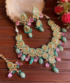 Adorn your beautiful personality with this exquisitely designed and handcrafted Kundan necklace set with meenakari back and lined with high quality handpainted mint green and pink tumbles.  Pair it up with your silks and satins and shine like a glowing star at the next event! Necklace length 18-20 inches with an adjustable zari dori at the back  Item includes: Necklace, earrings and maangtika  Earrings length 3.5 inches Each earring weighs 30 gms  Highest quality and craftsmanship Making time 3- Kundan Necklaces, Kundan Jewellery, Handmade Wedding, Indian Jewelry, Mint Green, Necklace Set, Beautiful Earrings, Jewelry Sets, Wedding Jewelry