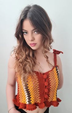 a woman with long hair wearing a crochet top