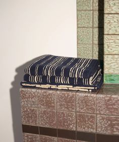 a towel sitting on top of a tiled counter