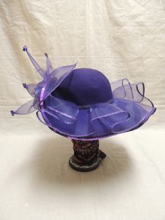 Vintage Purple Red Hat Society in Wool and Tulle with Sequins. This is a vintage Red wool hat society hat and is one size fits all. A beautiful purple floppy hat with brim turned up in the front, decorated with purple tulle, a purple sequined applique and tiny sequined at the end of each bough of tulle. The Red Hat Society is an international social organization that was founded in 1998 in the United States for women age 50 and beyond, but now open to women of all ages. Its main purpose is to pr Adjustable Purple Top Hat With Curved Brim, Purple Wide Brim Adjustable Costume Hat, Purple Adjustable Wide Brim Costume Hat, Purple Adjustable Hat For Kentucky Derby, Adjustable Purple Hat For Kentucky Derby, Adjustable Purple Felt Hat With Short Brim, Fitted Purple Wide Brim Top Hat, Adjustable Wide Brim Purple Mini Hat, Purple Hat With Short Brim For Royal Ascot