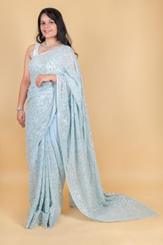 Take elegance to the next level with our stunning Georgette saree in a magnificent shade of blue. Adorned with delicate sequins, this saree exudes sophistication and luxury. Perfect for special occasions or to add a touch of glamour to your everyday look. Elevate your style with this exquisite saree. Georgette saree with sequins - Blue Saree comes with a blouse piece. Fall and pico done. Fully stitched blouse shown in pictures is optional and can be purchased seperately from our blouses and croptops section. For saree video please connect with us on whatsapp @469-937-0606 Ready to be shipped in USA from San Diego, California. All pictures are original pictures. Colors may slightly vary due to pic resolution. Bollywood Style Pre-draped Saree With Sequins, Blue Zari Work Party Wear Pre-draped Saree, Party Wear Pre-draped Saree With Sequins, Party Wear Traditional Drape With Sequins, Party Wear Traditional Sequined Drape, Diwali Pre-draped Sequined Saree, Glamorous Blue Pre-draped Saree, Designer Blue Sequined Sharara, Eid Wedding Pre-draped Saree With Sequins