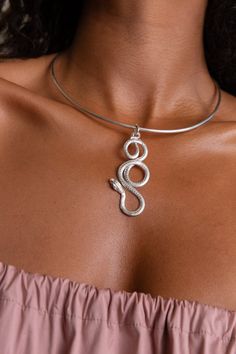 A single snake in 18K gold plated ancient bronze or sterling silver with sapphire eyes suspended on a 30” snake chain or a delicate neck cuff. Named after the goddess of healing Eir, this piece is a staple of The Rebirth collection. This timeless necklace is inspired by ancient Greek and Egyptian jewelry. I’ve envisaged the snake as the symbol of life and regeneration, healing, and growth. I hope it will serve as a talisman of power and protection. Total length 2.7'' Total width 1'' Spiritual Metal Jewelry In Snake Shape, Unique Metal Jewelry With Snake Shape, Unique Snake-shaped Metal Jewelry, Spiritual Snake-shaped Metal Jewelry, Silver Snake Jewelry With Adjustable Chain, Snake-shaped Metal Jewelry With Adjustable Chain, Snake Shaped Metal Jewelry With Adjustable Chain, Metal Snake-shaped Clavicle Chain Jewelry, Metal Snake-shaped Jewelry With Adjustable Chain