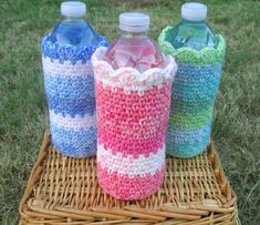 three water bottles sitting on top of a wicker basket