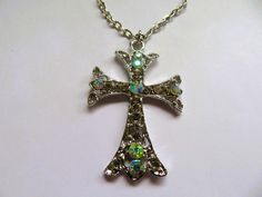 Beautiful ornate filigree silvertone  cross/pendant-30 x 50mm-covered with CZ crystals -comes with 20 inch extendable silver chain. A beautiful gift. For more items see my shop at https://www.merlinscaveshop.co.uk Elegant Rhinestone Cross Necklace As Gift, Silver Cross Necklaces For Wedding, Silver Necklace With Rhinestones For Gift, Silver Cross Jewelry With Bling, Elegant Silver Metal Cross Necklace, Crystal Rhinestone Cross Necklace Perfect For Gifts, Silver Metal Cross Necklace As Gift, Silver Sparkling Rhinestone Necklace For Gift, Silver Cross Necklace With Large Pendant