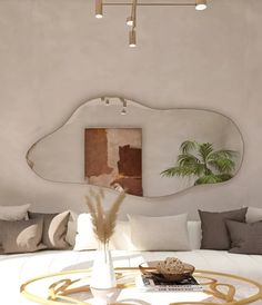 a living room with a round coffee table in front of a large mirror on the wall