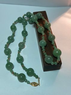 This is a beautiful, vintage, natural, genuine 14K yellow gold, green jade and 14K gold beads necklace. The necklace is about 25 1/2 inches.  The necklace is so unique and features large, natural, round green jade that is 13mm (about 1/2" in diameter) then there are 2 smaller, natural, round green jade that are 5mm (about 3/16" in diameter) separated with a 14K yellow gold bead that is about 1/8" in diameter. So there are 4 smaller green jade balls and 1 14K yellow gold bead between each of the larger green jade balls. The high-quality jade is a gorgeous green color. Just stunning and very well-made. The necklace has a secure 14K slide clasp that is ornate with a flower on it. The necklace weighs an impressive 58.2 grams. It is marked 14K WW. I am unsure who the artisan is who uses that ha Swamp Princess, Gold Beads Necklace, Vintage Navajo Jewelry, Green Jade Necklace, Jade Bead Necklace, Tibetan Jewelry, Navajo Jewelry, Gold Bead Necklace, Jade Necklace