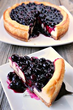 two plates with blueberry cheesecake on them