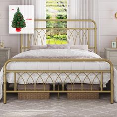 there is a bed with a metal frame and a christmas tree on the headboard