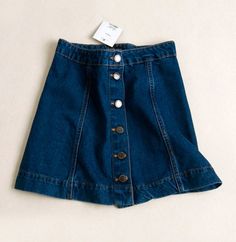 Haven't got the latest button-down denim skirt yet? Swap your boring mini skirts with this on-trend piece!This denim skirt featuring a button-down detail is one of the most popular trend RN in 2016. The A-line and high-waisted details can help elongate your legs and make your waist looks smaller. Style this minis with turtleneck top and wedges for that retro 60's vibes! Not comfortable in flashing.. Trendy Dark Wash Skirt With Button Zip Fly, Cotton Mini Denim Skirt With Button Closure, Cotton Denim Mini Skirt With Button Closure, Mini Cotton Denim Skirt With Button Closure, Medium Wash Denim Mini Skirt With Button Zip Fly, Casual Mini Skirt With Button Zip Fly, Spring Mini Skirt With Button Zip Fly, Dark Wash Button Closure Skirt For Fall, High-waisted Buttoned Denim Blue Mini Skirt